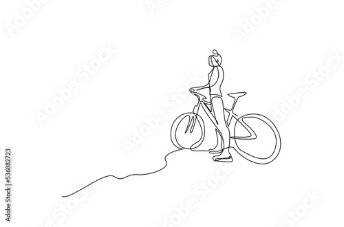a young woman girl rides a bike outside in the hills