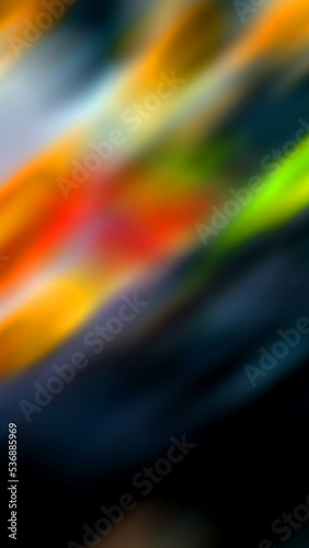 Abstract blurred background with lots of color on the top and black on the bottom.