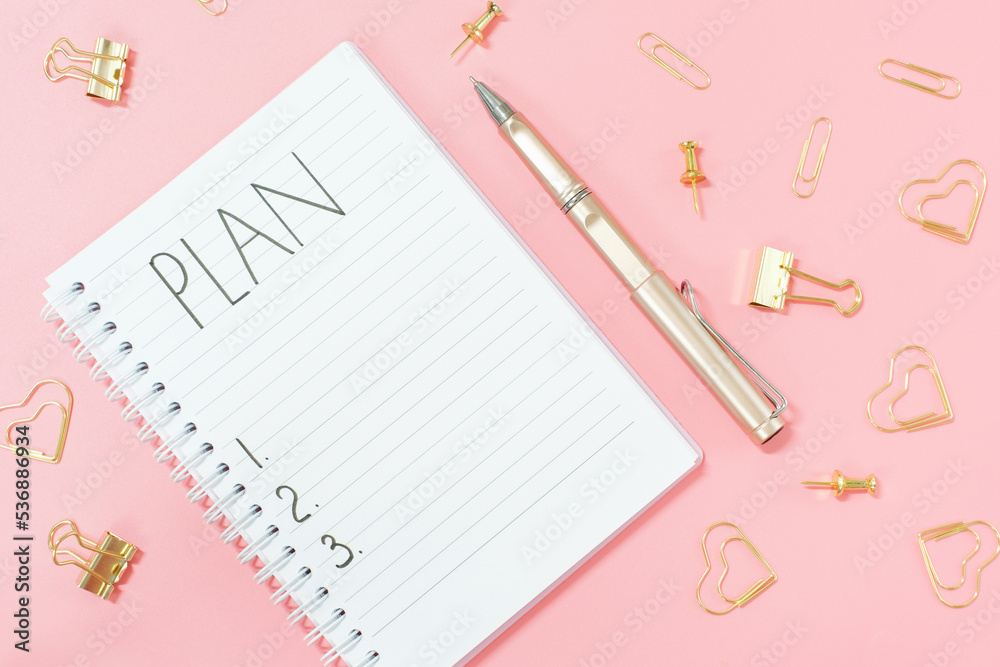 Inscription plan in blank notepad and stationery on pink background copy space. Inscription plan in blank notepad and stationery on pink background copy space.