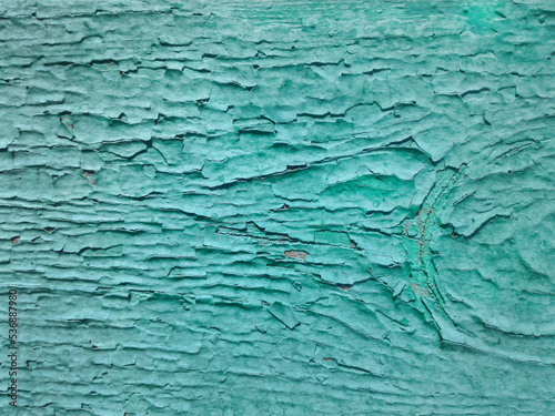 Texture of old cracked turquoiseturquoiseturquoise paint paint on the wooden surface. Background  close-up