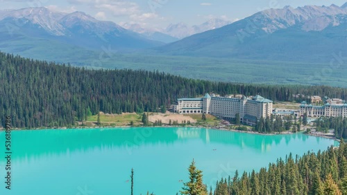 4K time-lapse UHD video of beautiful panoramic view of Lake Louise, a glacier mountain lake in Banff National Park, and Fairmont Chateau Hotel from a side view on a sunny summer day, Alberta, Canada photo