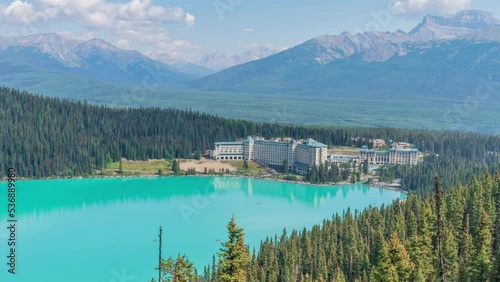 4K time-lapse UHD video of beautiful panoramic view of Lake Louise, a glacier mountain lake in Banff National Park, and Fairmont Chateau Hotel from a side view on a sunny summer day, Alberta, Canada photo