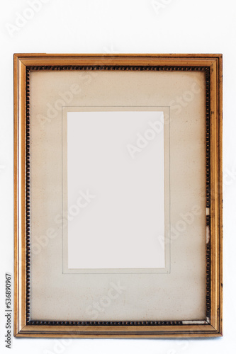Old gilt leaf frame with missing parts and aged passpartout whithout center image photo