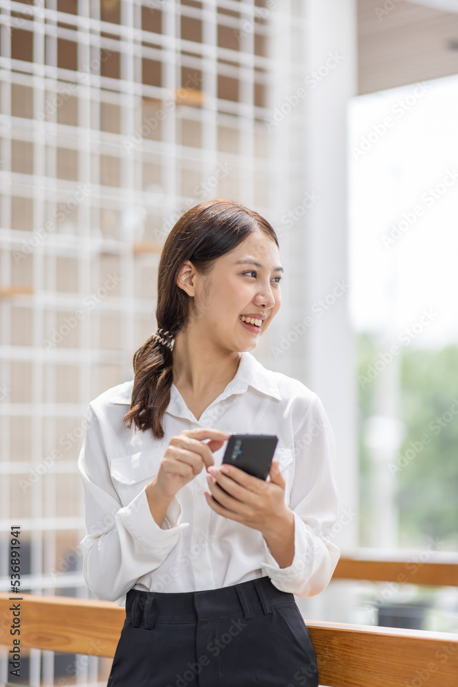 Happy millennial hispanic teen girl checking social media holding smartphone at home. Smiling young asian woman using mobile phone app playing game, shopping online, ordering delivery relax on desk. Happy millennial hispanic teen girl checking social media holding smartphone at home. Smiling young asian woman using mobile phone app playing game, shopping online, ordering delivery relax on desk.