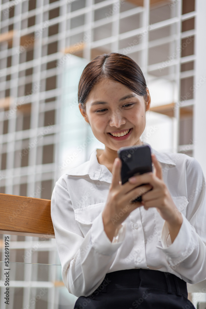 Happy millennial hispanic teen girl checking social media holding smartphone at home. Smiling young asian woman using mobile phone app playing game, shopping online, ordering delivery relax on desk. Happy millennial hispanic teen girl checking social media holding smartphone at home. Smiling young asian woman using mobile phone app playing game, shopping online, ordering delivery relax on desk.