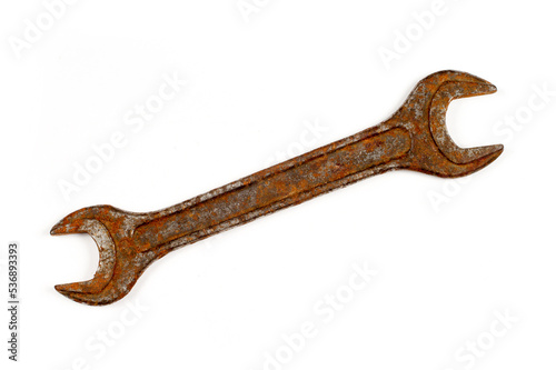 An old rusty wrench on a white background.
