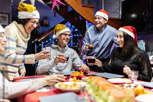 Group of hispanic latin people social gathering for new year dinner - Multi generational family celebrating christmas holidays
