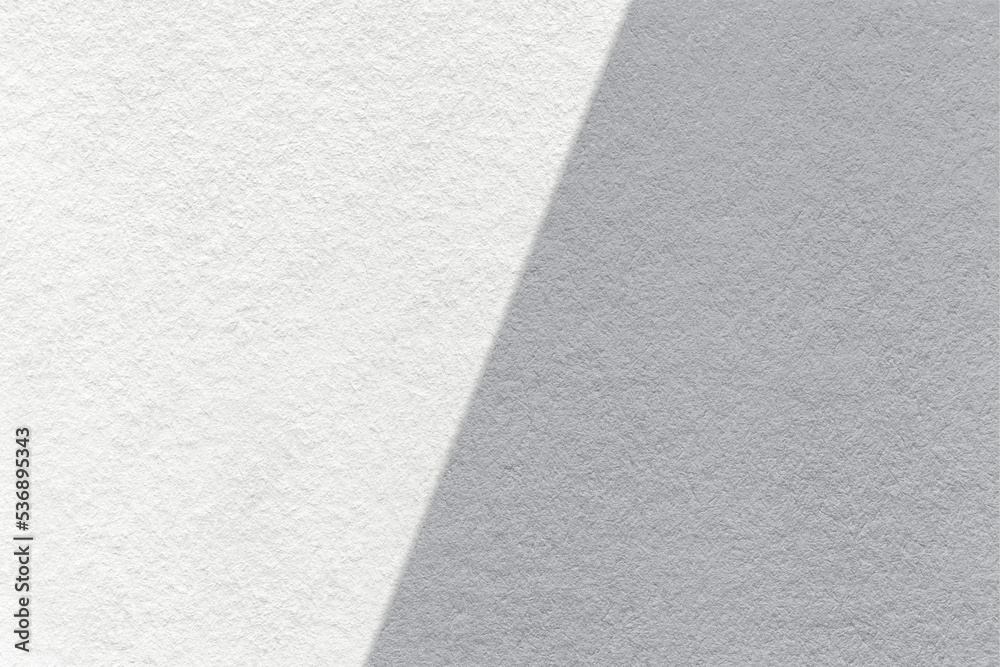 Texture of craft white and gray paper background, half two colors, macro. Vintage dense kraft grey cardboard.
