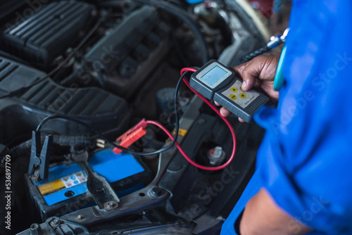 Auto mechanics use a multimeter voltmeter to measure the voltage in the car battery.