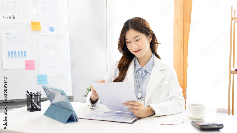 Asian business women are analyzing graphs, Financial statistics and calculating corporate returns in private offices, Market research reports and income statistics, Financial and Accounting concept.