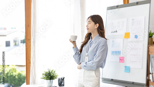 Office worker with a beautiful Asian woman in a private office, Daily routine of office workers, Welcome to work in the morning with a bright smile, Businesswoman in office concept.