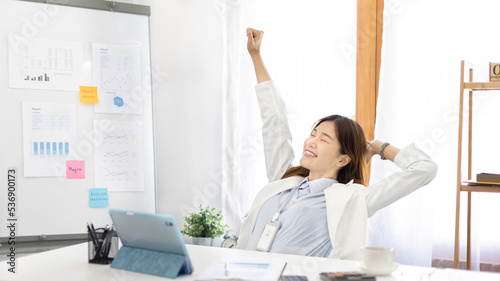 Female employee is doing a relaxing posture after a hard Midday's work, Happy women resting at work after work is finished, Fatigue is eased, Relax, Attractive, Stretch oneself, Stretch out the arms.