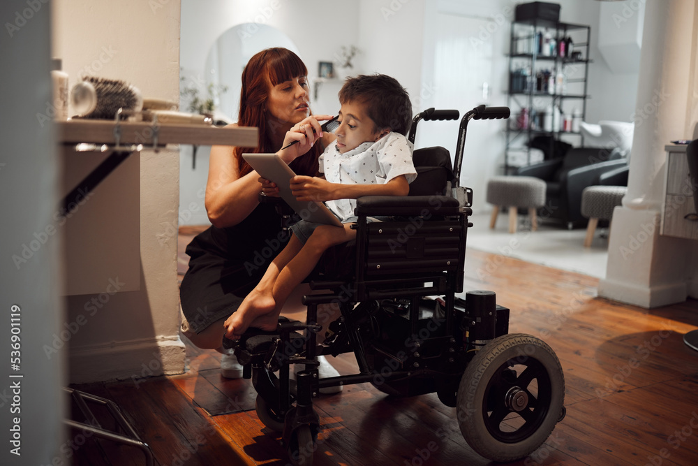 Hair, beauty and inclusive barber grooming child in a wheelchair, relax while digital tablet and comfort. Care, disability and child development with handicapped boy enjoying pamer treatment haircut Hair, beauty and inclusive barber grooming child in a wheelchair, relax while digital tablet and comfort. Care, disability and child development with handicapped boy enjoying pamer treatment haircut