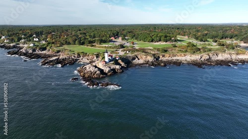 Scenic New England coastline. Rocky shore in Portland Maine with lighthouse during autumn color. Aerial truck shot. Beautiful maritime scene. photo