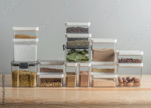 plastic containers with dry spices on a kitchen