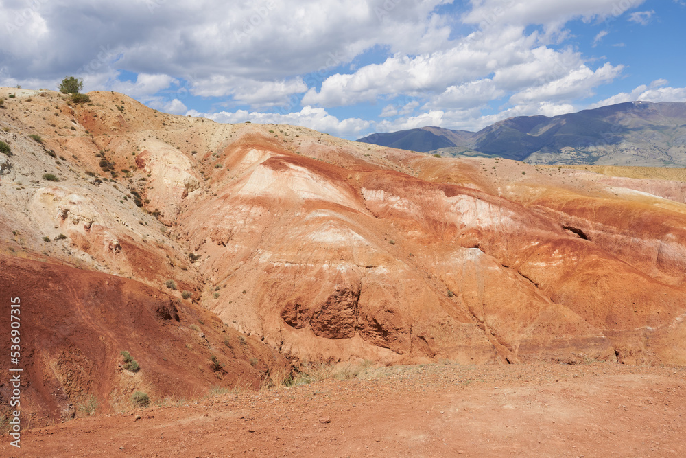 Altai Mountains, Mars 1 - red mountains against a background of blue sky with clouds.