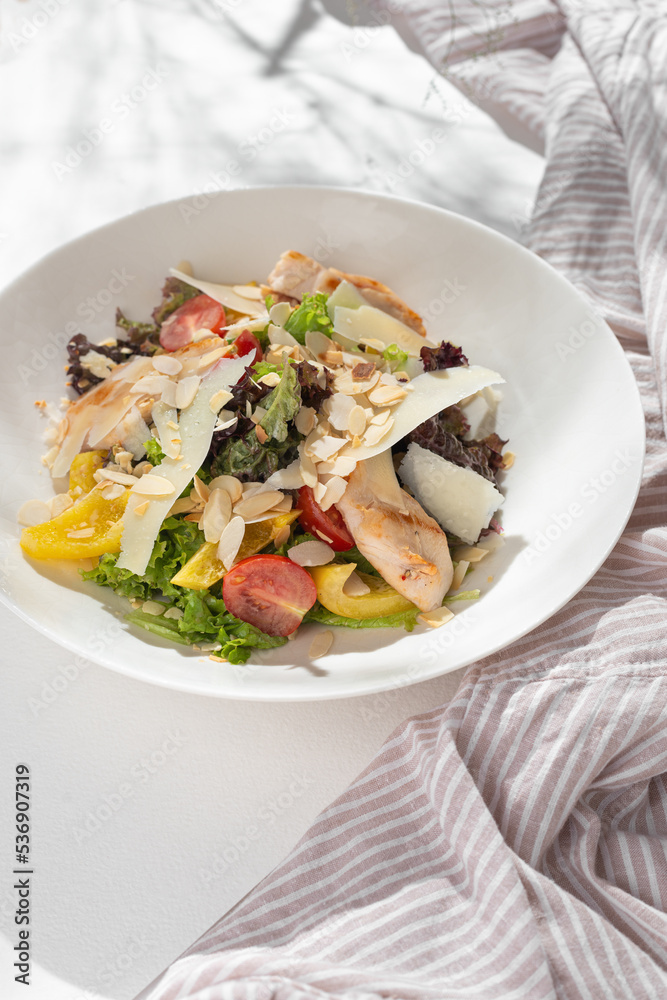 Classic caesar salad with grilled chicken fillet and parmesan cheese. Classic caesar salad with grilled chicken fillet and parmesan cheese.