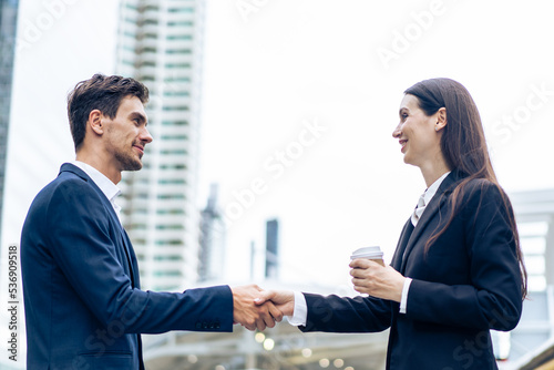 Caucasian businessman and businesswoman handshake outdoor in the city. 