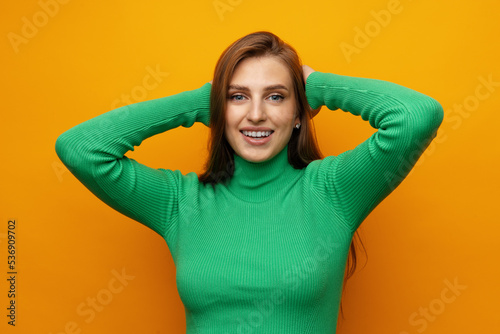 Pretty young woman smiling over yellow isolated background © fotofabrika