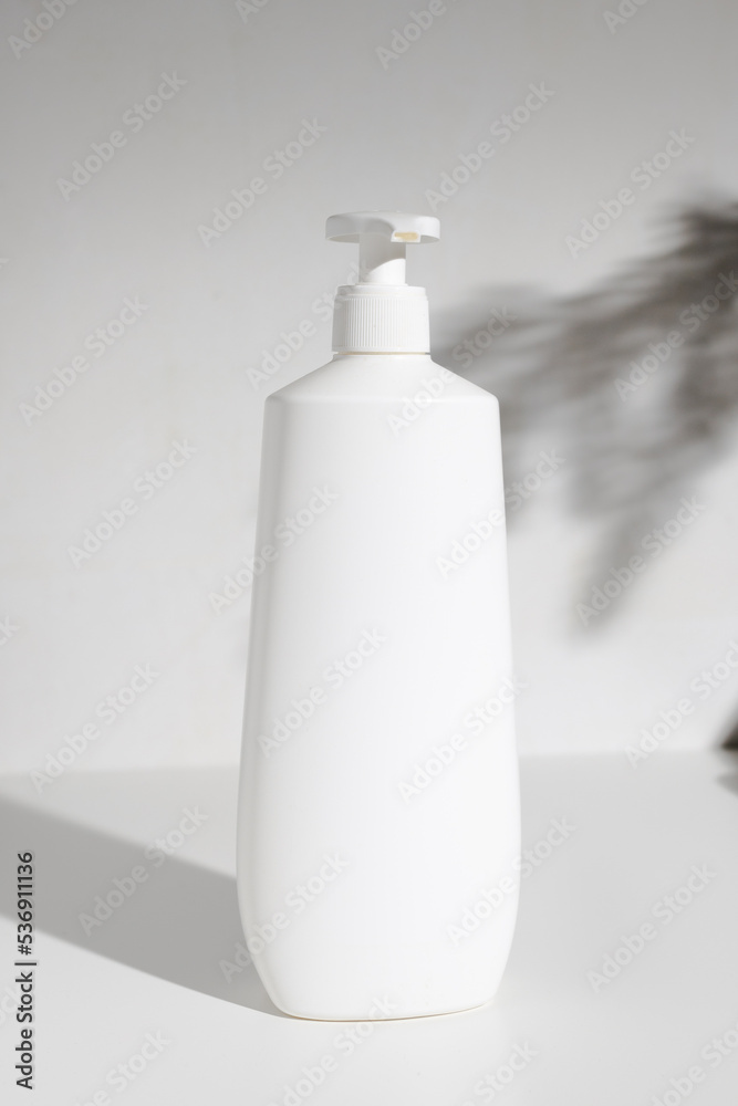 Cosmetic bottle with dispenser for mockup with shadows Cosmetic bottle with dispenser for mockup with shadows