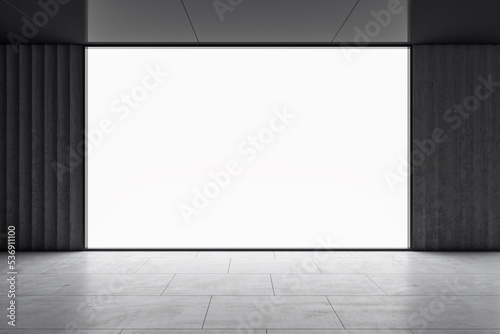 Fototapeta Naklejka Na Ścianę i Meble -  Front view on big blank white illuminated screen with place for your logo or text in empty room with glossy dark ceiling and grey floor. 3D rendering, mock up