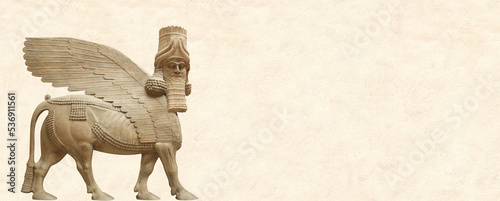 Grunge background with stone texture and lamassu. Horizontal banner with assyrian protective deity photo