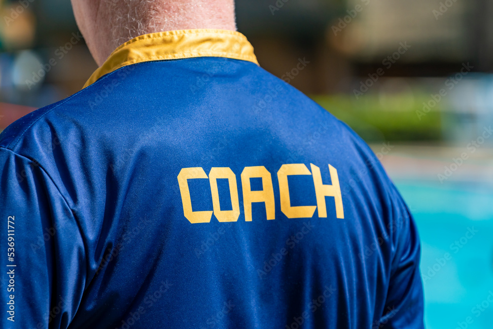 Fototapeta premium Back view of swimming coach, wearing COACH shirt