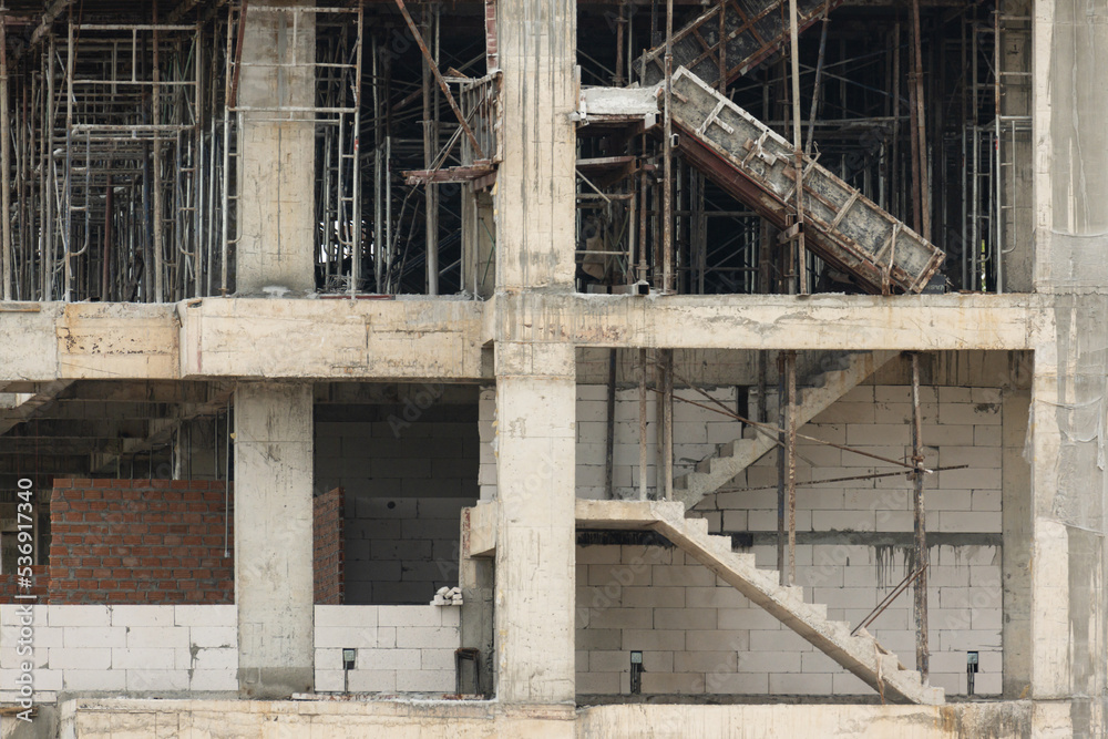 Unfinished cement building at a construction site.Cement pouring into formwork of building at construction site.A new residential build concept.