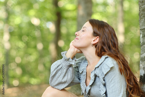 Fotografie Happy woman relaxing in a forest