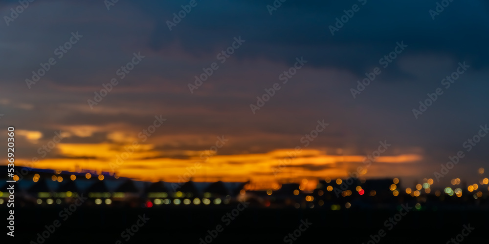 dark blurred background with sunset over the city