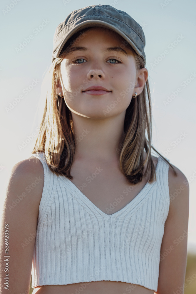 Smiling cute girl wearing cap on sunny day Stock Photo Adobe Stock