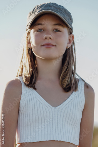 Smiling cute girl wearing cap on sunny day