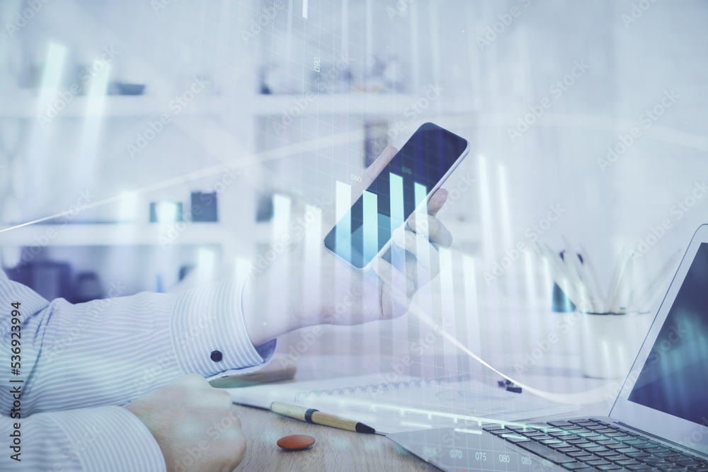 Double exposure of man's hands holding and using a digital device and forex graph drawing. Financial market concept. Double exposure of man's hands holding and using a digital device and forex graph drawing. Financial market concept.