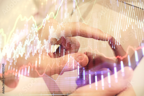 Wallpaper Mural Multi exposure of man's hands holding and using a phone and financial chart drawing. Market analysis concept. Torontodigital.ca