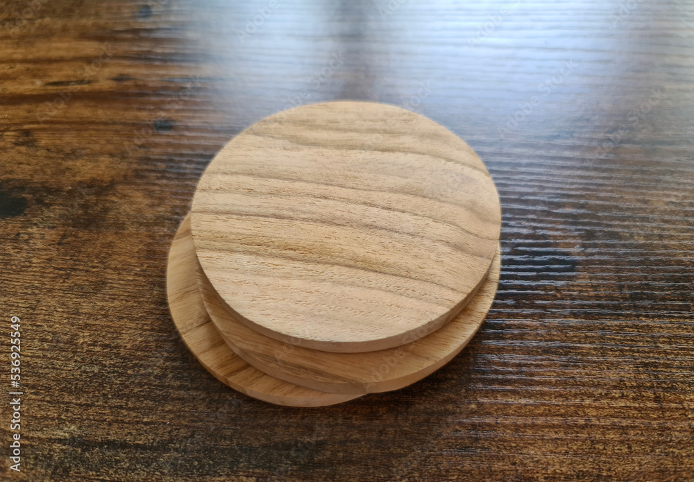 Blank coaster stack mockup with wood texture on wooden surface. Circular drink pad pile template Blank coaster stack mockup with wood texture on wooden surface. Circular drink pad pile template