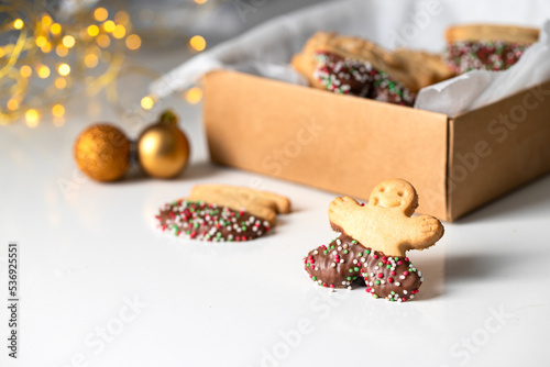 Christmas cookies . Man shape butter cookies on white background with bokeh, typical festive treat