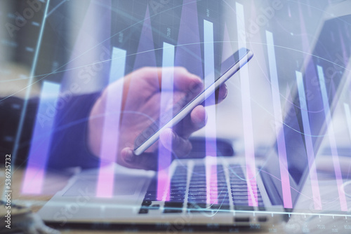 Wallpaper Mural Double exposure of man's hands holding and using a phone and financial graph drawing. Analysis concept. Torontodigital.ca