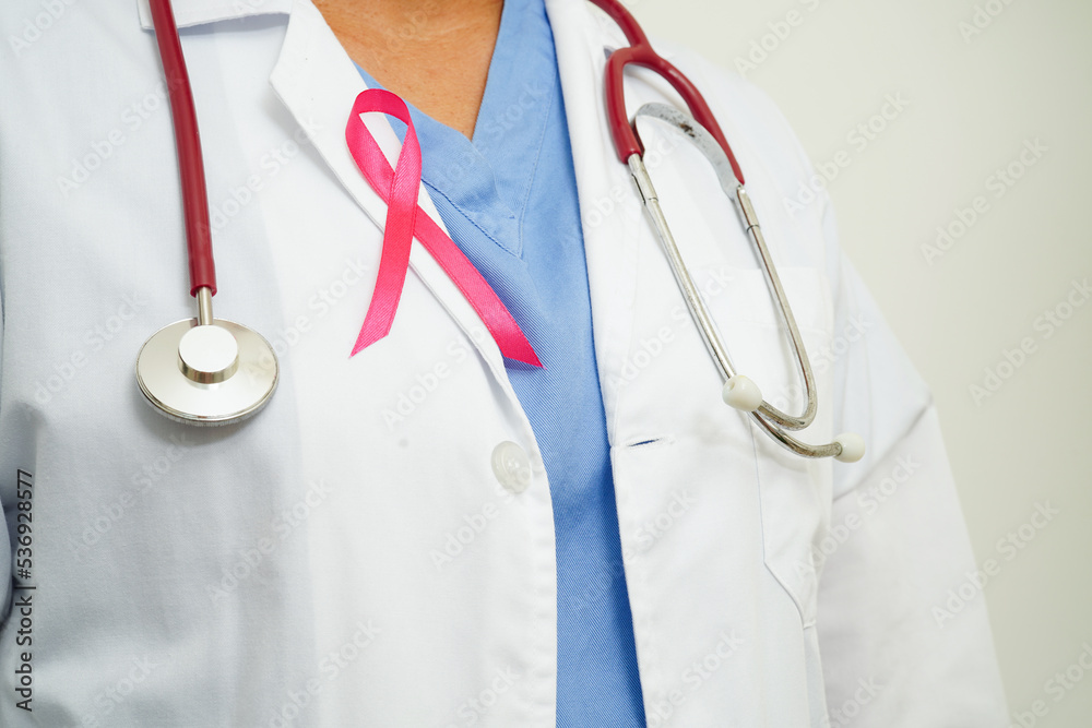 Asian woman doctor with pink ribbon, World Breast Cancer Day at October. Asian woman doctor with pink ribbon, World Breast Cancer Day at October.