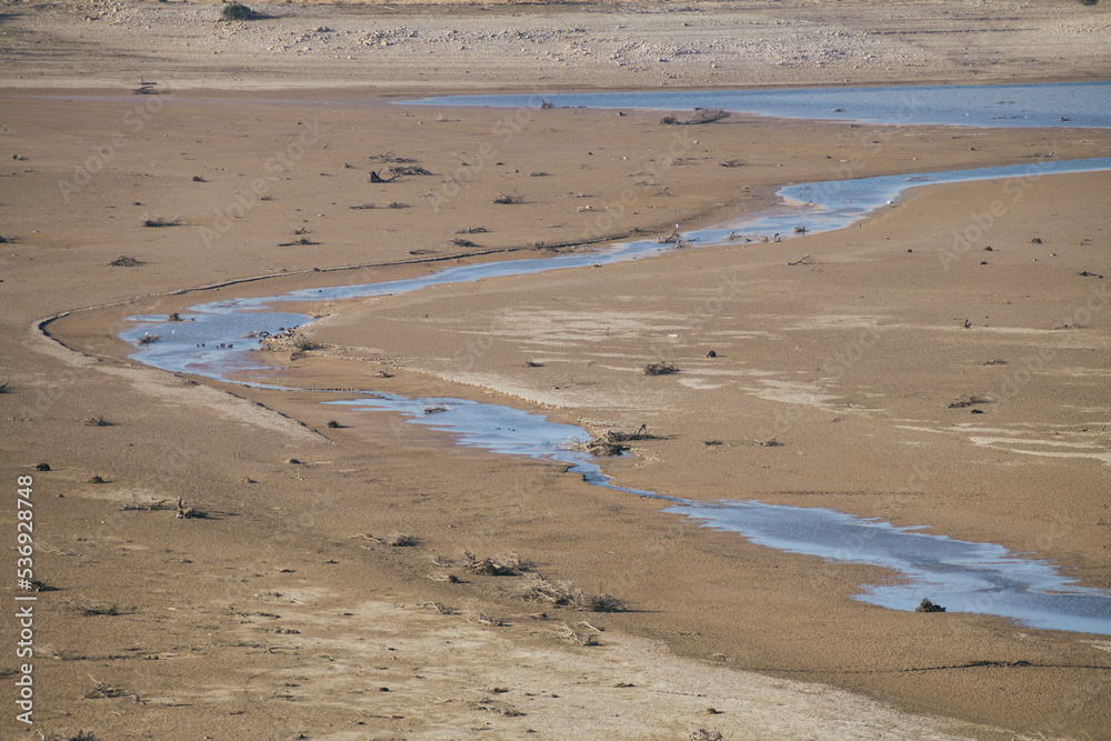 Concept: drought. Large river bed with low flow level due to global warming and climate change.