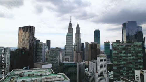 Pullback On Petronas Twin Towers Revealed Menara AIA Sentral Building In Kuala Lumpur, Malaysia. Aerial Shot photo