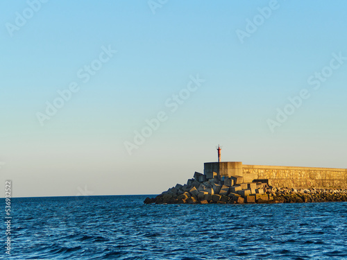 Breakwater in the sea at sunset