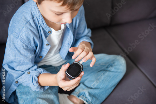 Child boy checking blood sugar level by Digital Glucose meter. Health care and Medical, diabetes, glycemia concept