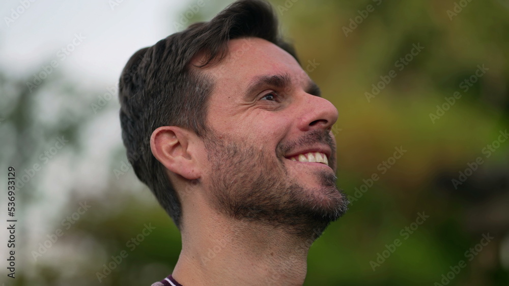 Spiritual man closing eyes in contemplation outdoors. Carefree person opening eye looking up at sky smiling with HOPE and FAITH. Grateful emotion Spiritual man closing eyes in contemplation outdoors. Carefree person opening eye looking up at sky smiling with HOPE and FAITH. Grateful emotion