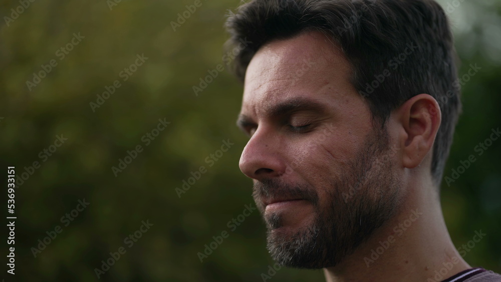 Spiritual man closing eyes in contemplation outdoors. Carefree person opening eye looking up at sky smiling with HOPE and FAITH. Grateful emotion Spiritual man closing eyes in contemplation outdoors. Carefree person opening eye looking up at sky smiling with HOPE and FAITH. Grateful emotion