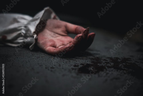 Closeup hand with blood of horror bloodthirsty ghost woman on floor, Homicide female hands jerky in blood with resentment torture and ask for help, murder and crime, Halloween horror day concept