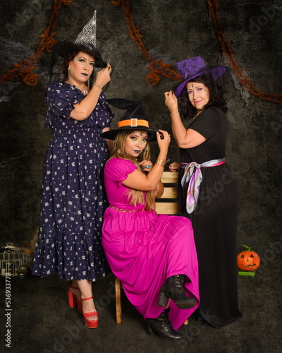 Studio portrait of three women of different ages dressed as witches.