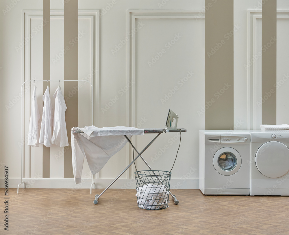 Washing dryer machine and ironing table interior style, laundry room, white  and brown vertical wall background. Stock Photo | Adobe Stock