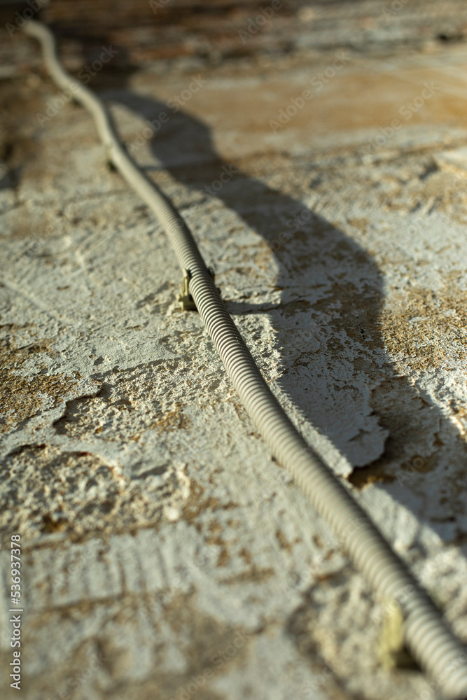 Wire on wall. Electrical wiring in building. Current insulation, Wire on wall. Electrical wiring in building. Current insulation,