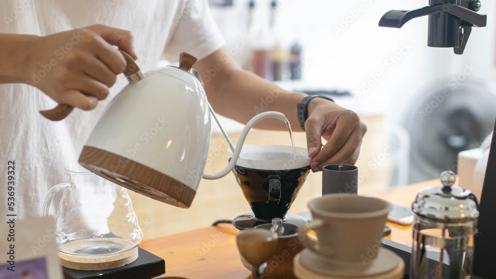 Barista is making drip brewing, filtered coffee, or pour over coffee