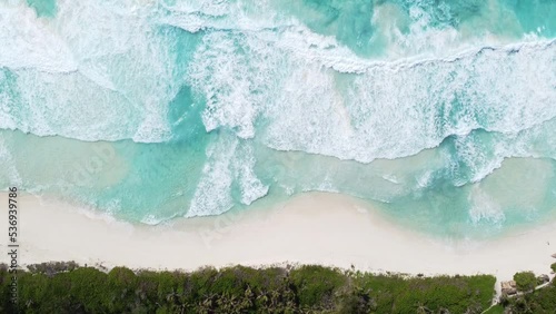 Top view from a drone. Turquoise water background with wave, sand and jungle view. Summer seascape.